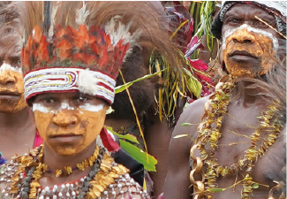A PHOTO OF TWO MEN DRESSED IN TRADITIONAL PAPUA  NEW GUINEA TRIBAL COSTUMES